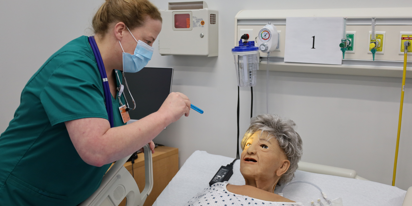 nursing student working with simulation doll