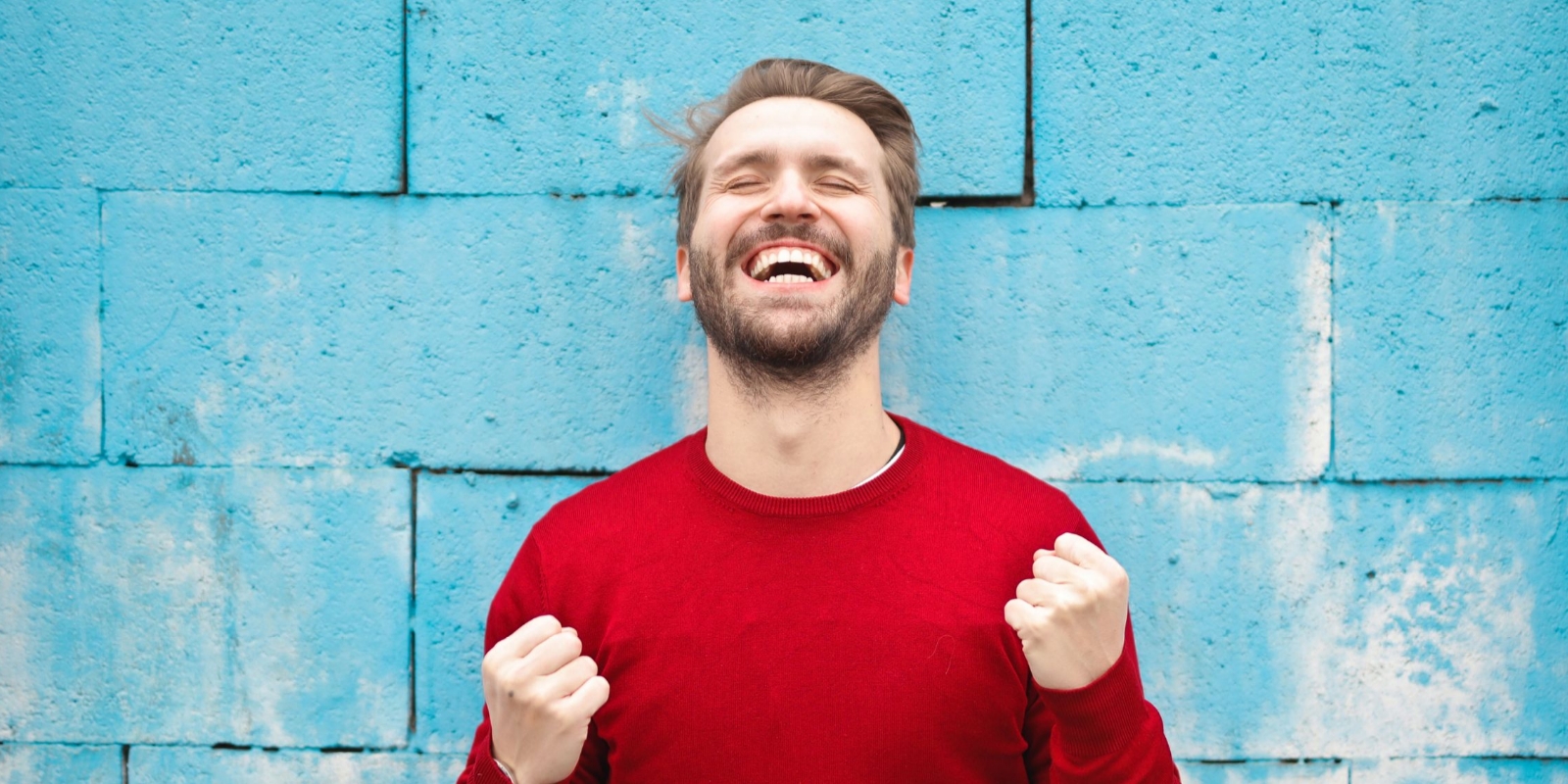 excited and happy man in red sweater