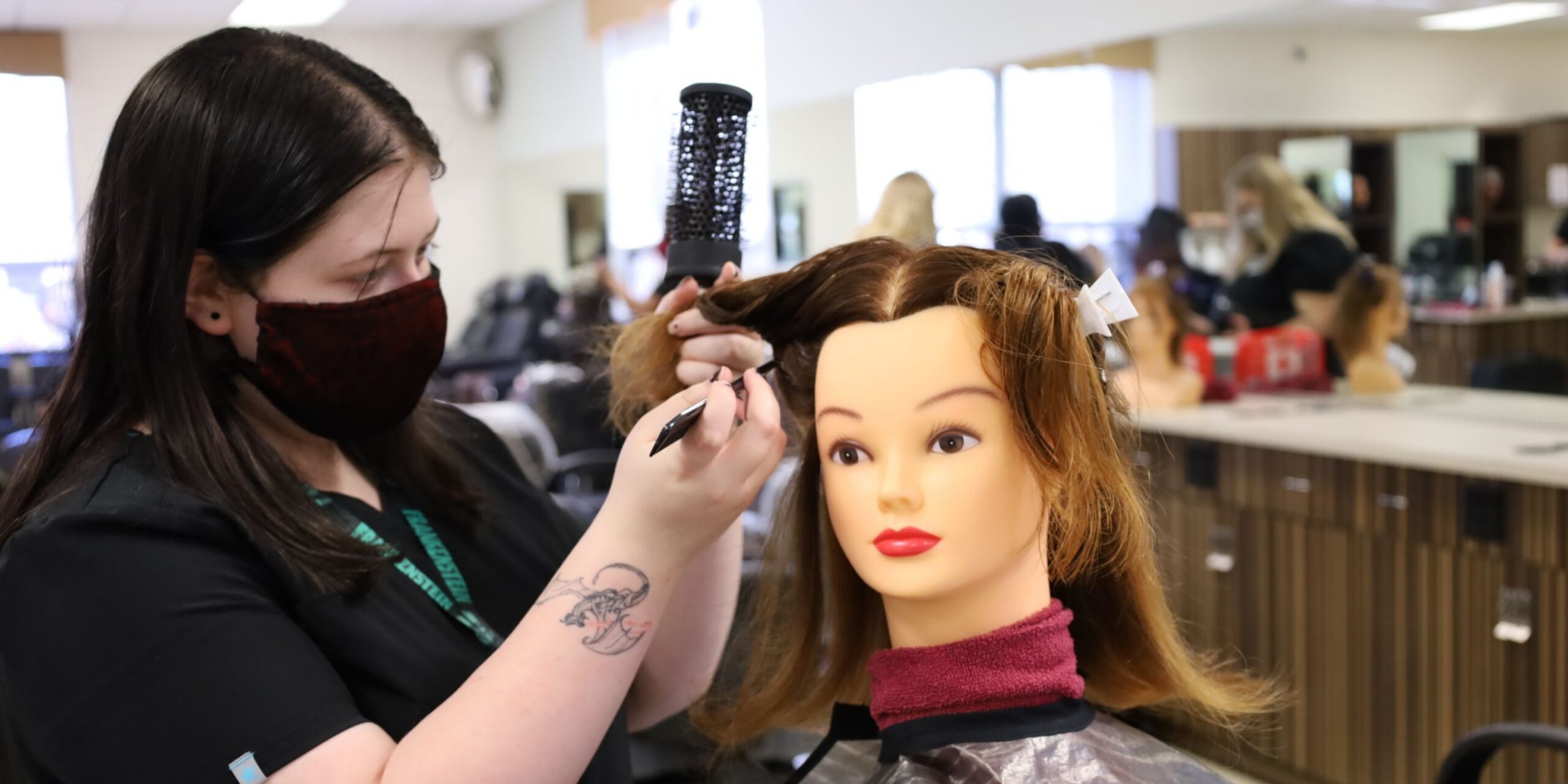 cosmetology student practicing hair styling