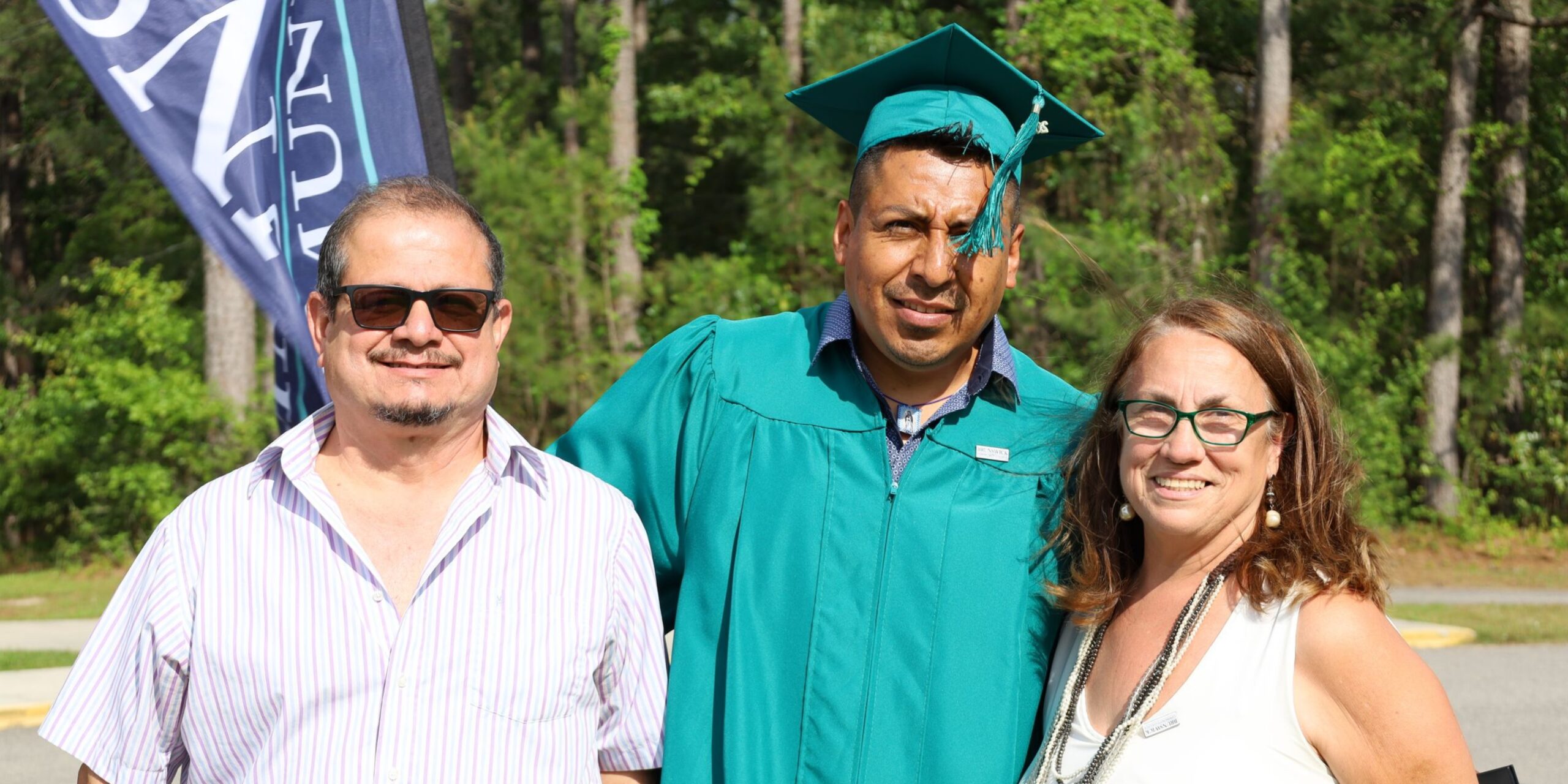Adult Education graduate with family and instructor