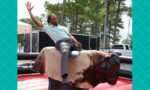 employee riding mechanical bull