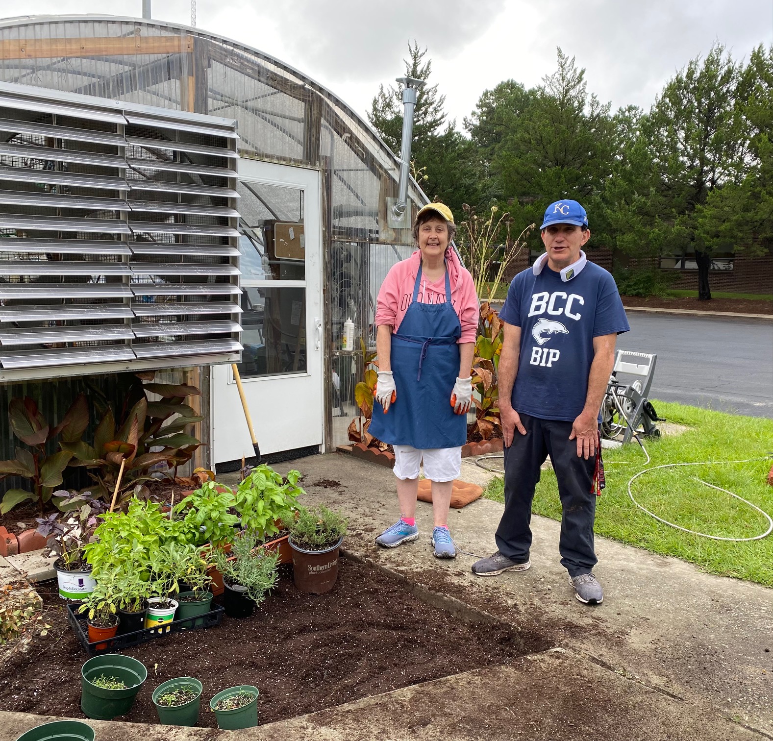 Students working in Brunswick Blooms greenhouse