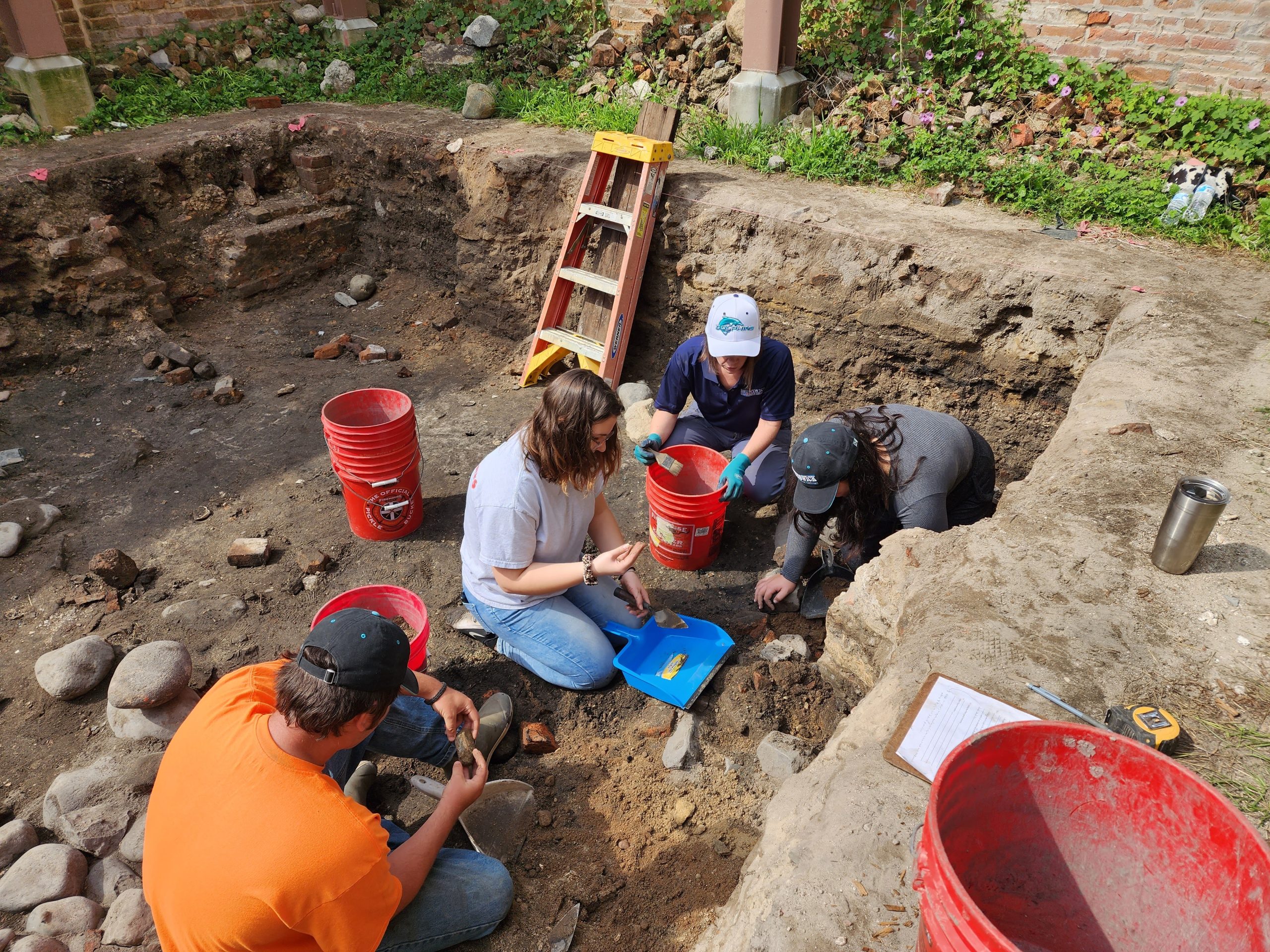 BCC instructor and students at an offsite field trip to an archeological dig