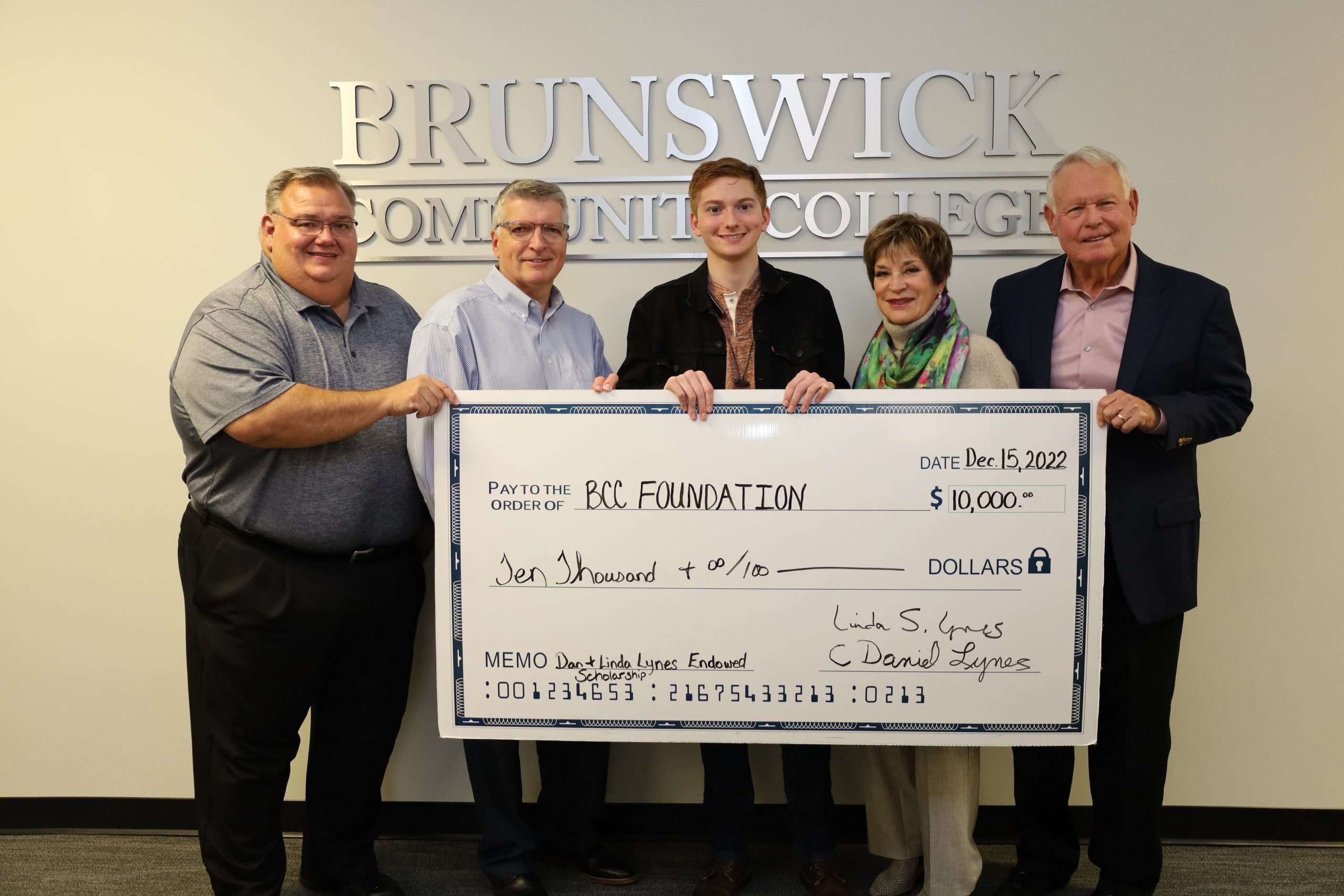 five people holding a giant check as part of a donation to the BCC Foundation