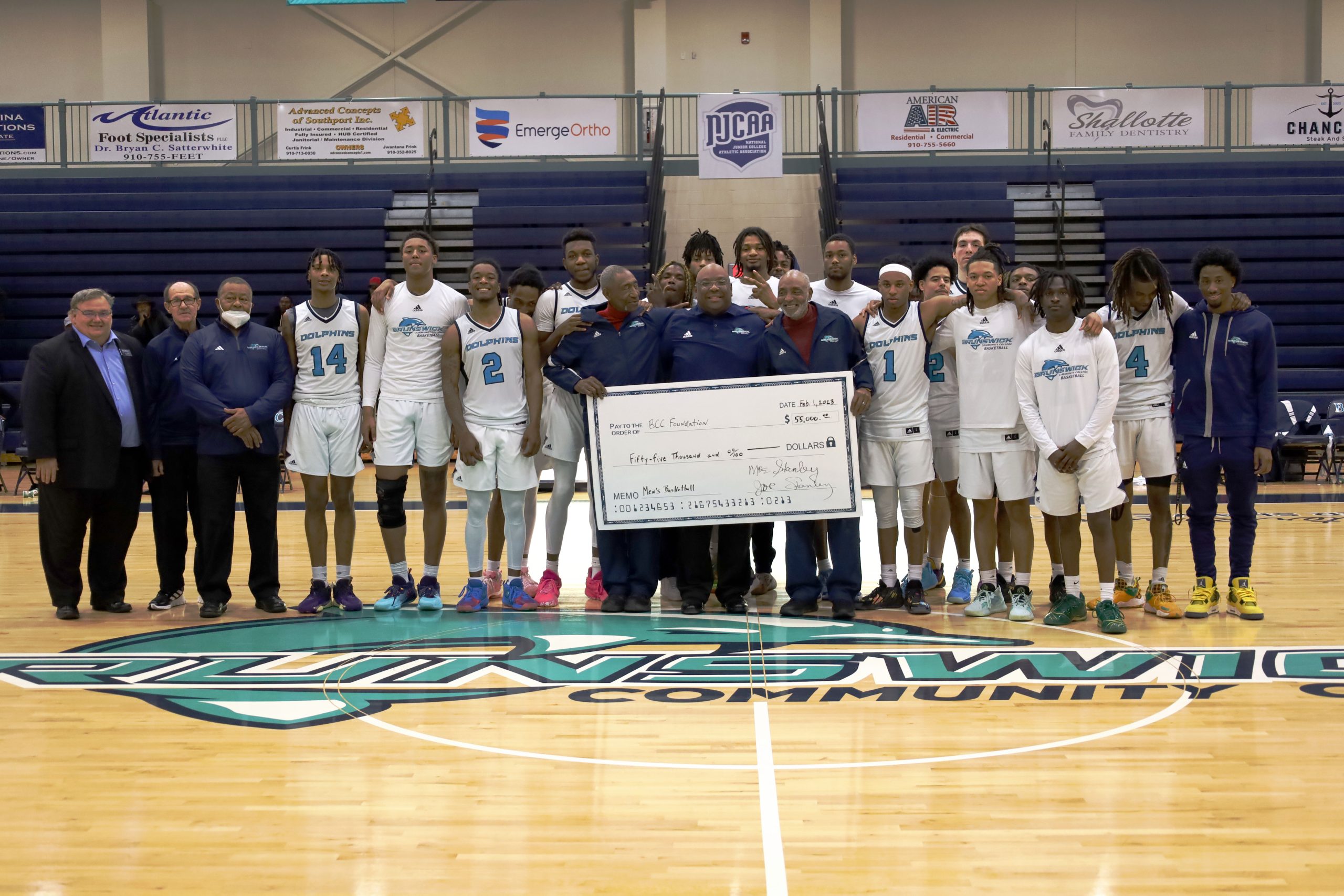 Stanley Brothers present $55,000 check to BCC Foundation at Dolphins Basketball Game