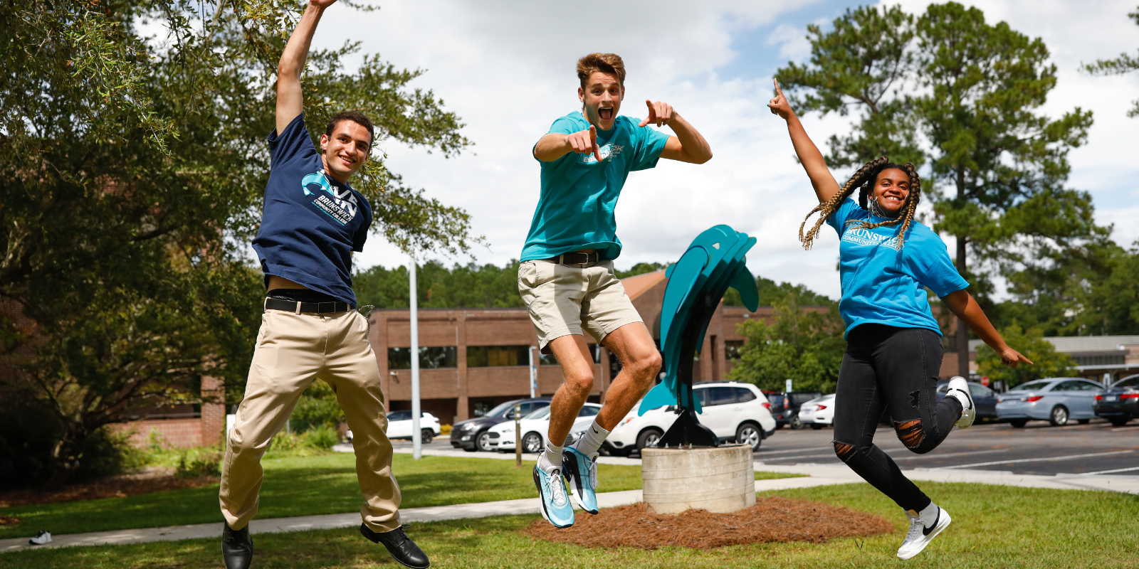 three students excitedly jumping into the air