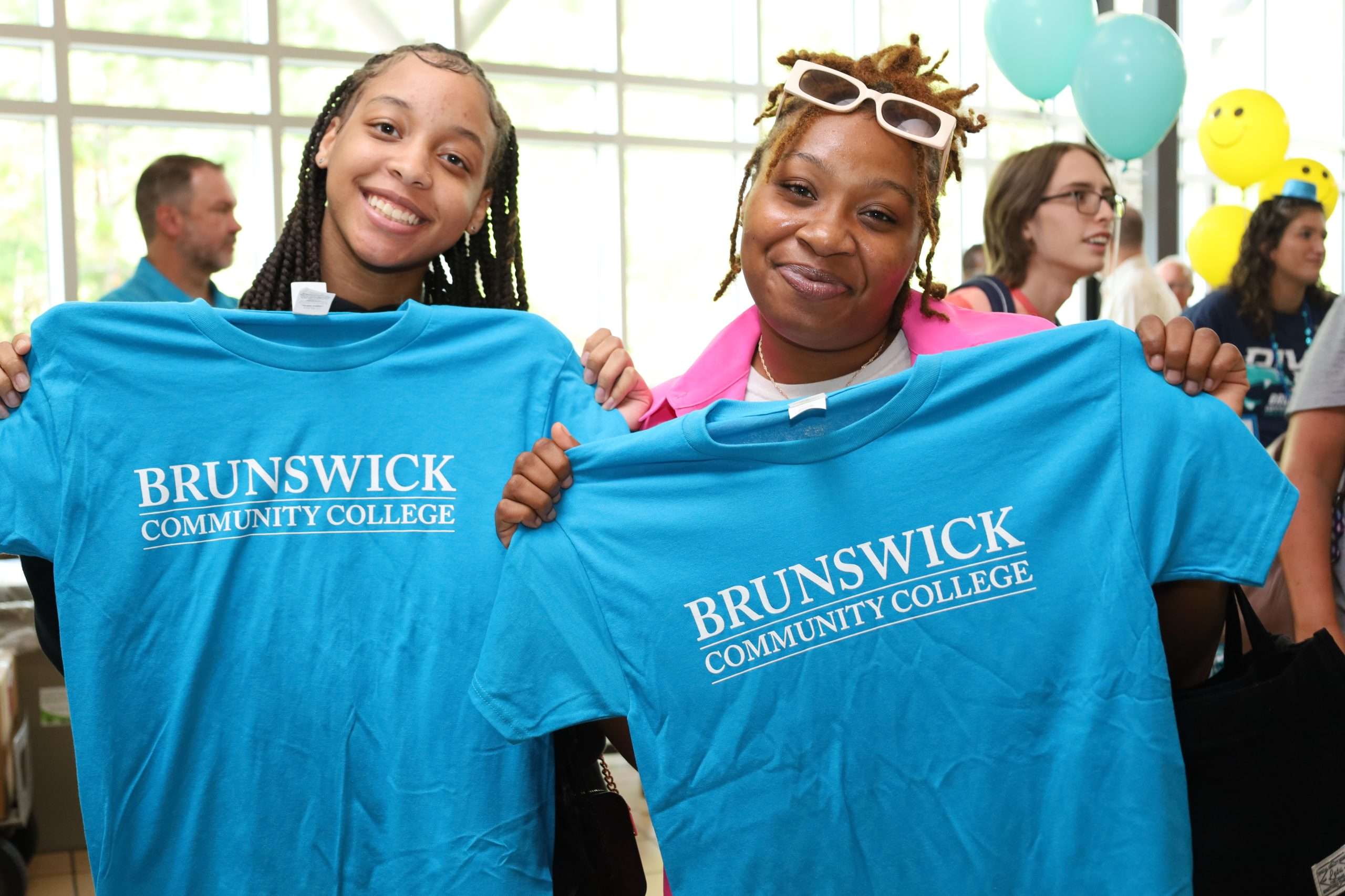 Two students displaying BCC shirts on opening day orientation